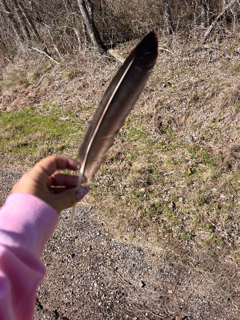 woman holding a feather